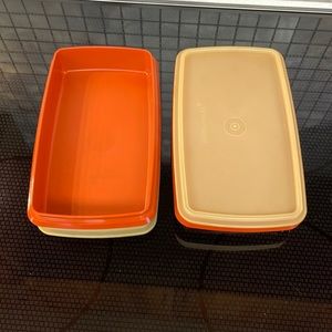 Two 9” x 5” burnt Orange Tupperware storage containers when lids.